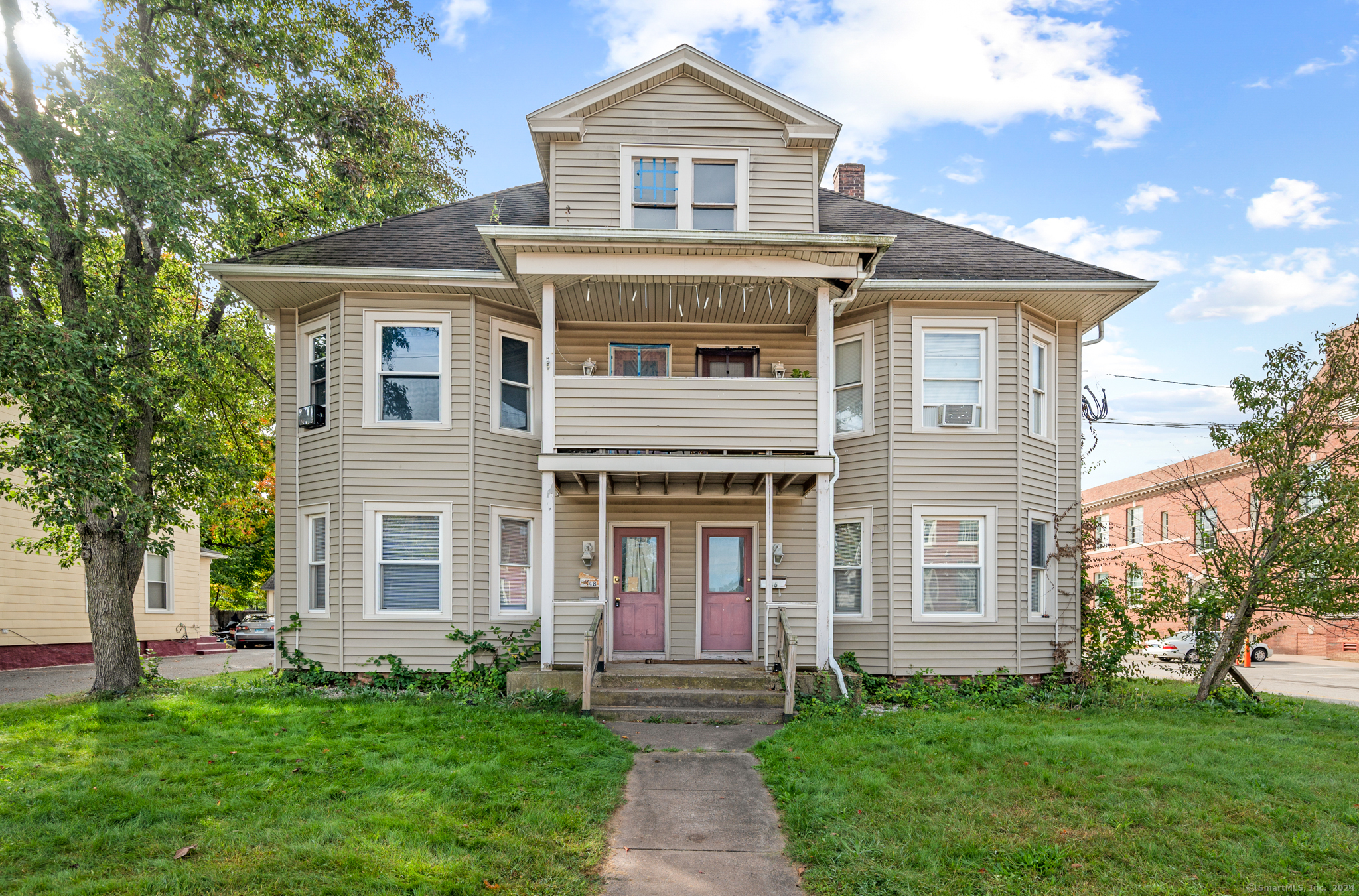 a front view of a house with a garden