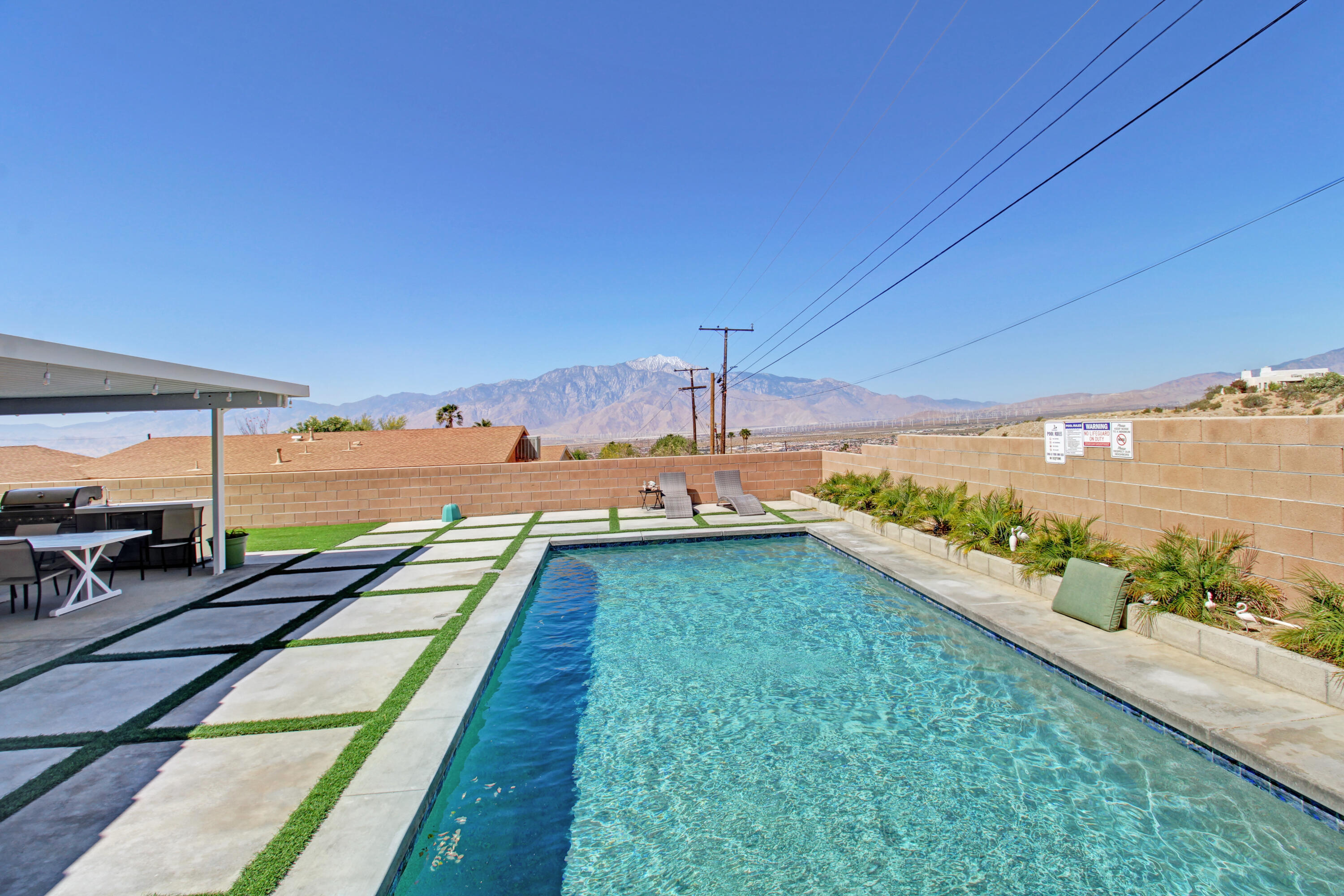 a view of a swimming pool and an outdoor seating