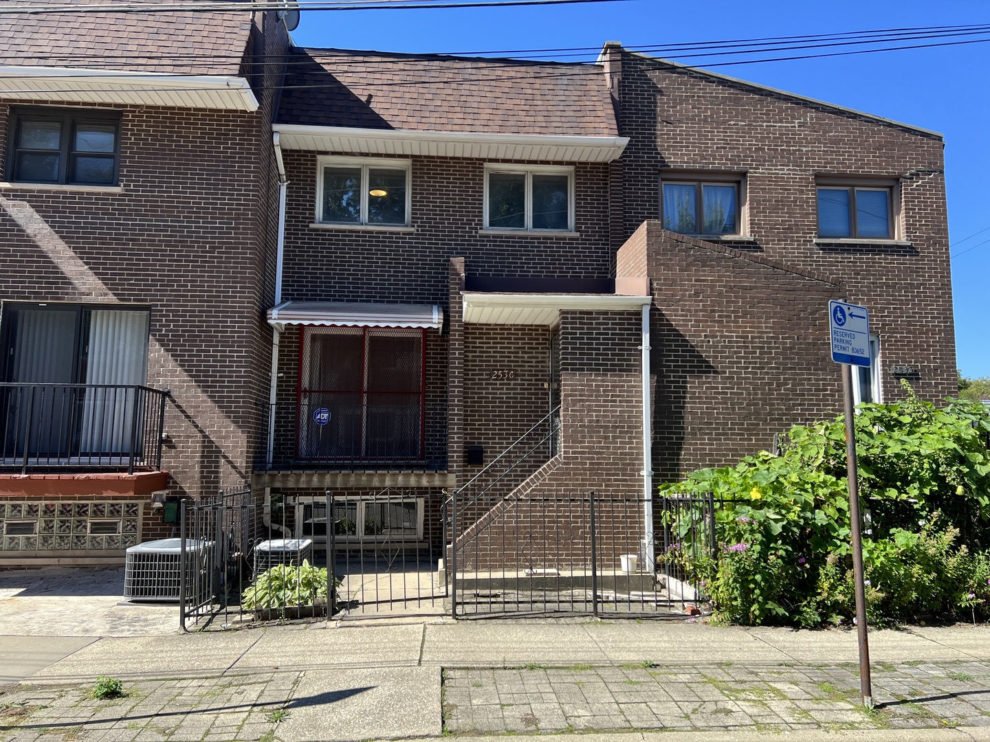 a brick house that has lots of windows on it