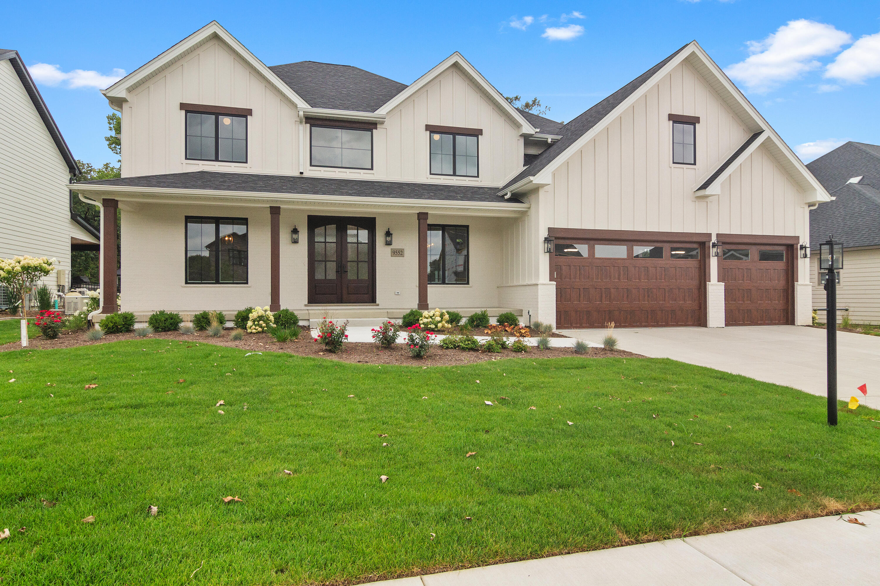 a front view of a house with a yard and garage