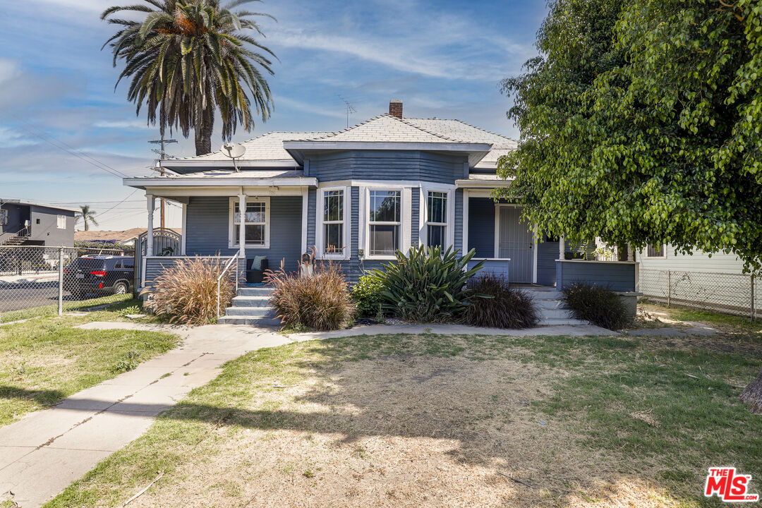 a front view of a house with garden and porch