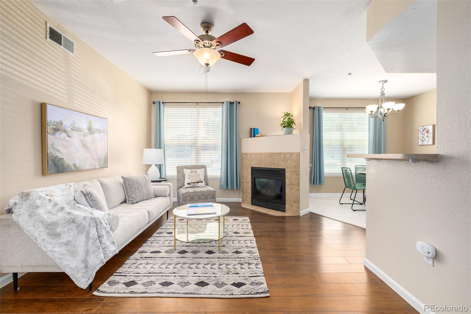 a living room with furniture and a fireplace