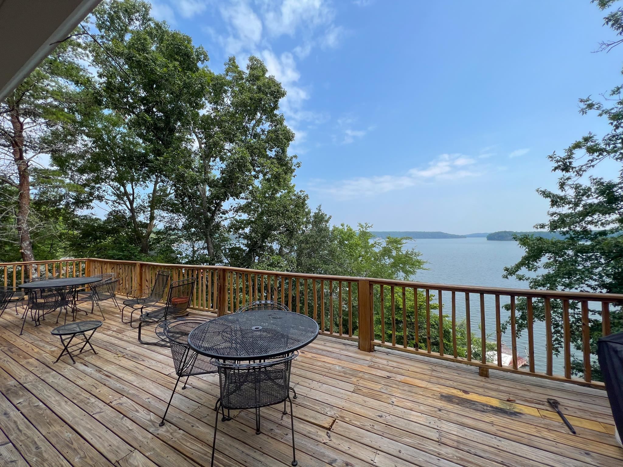 a view of a deck with wooden floor and outdoor seating