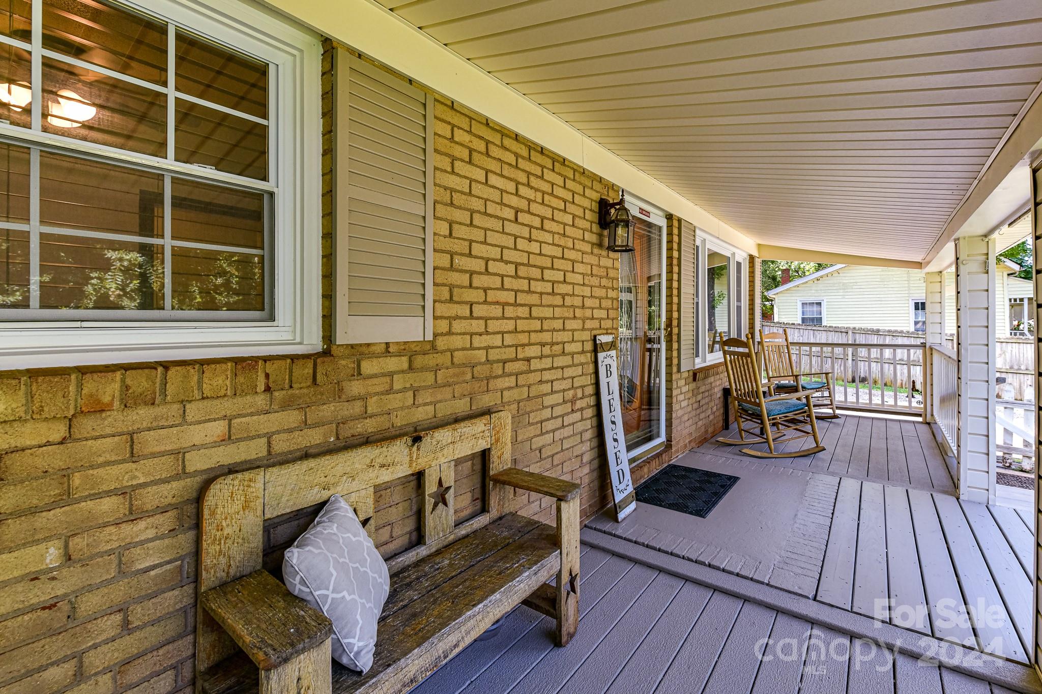 a view of a balcony with wooden floor and furniture