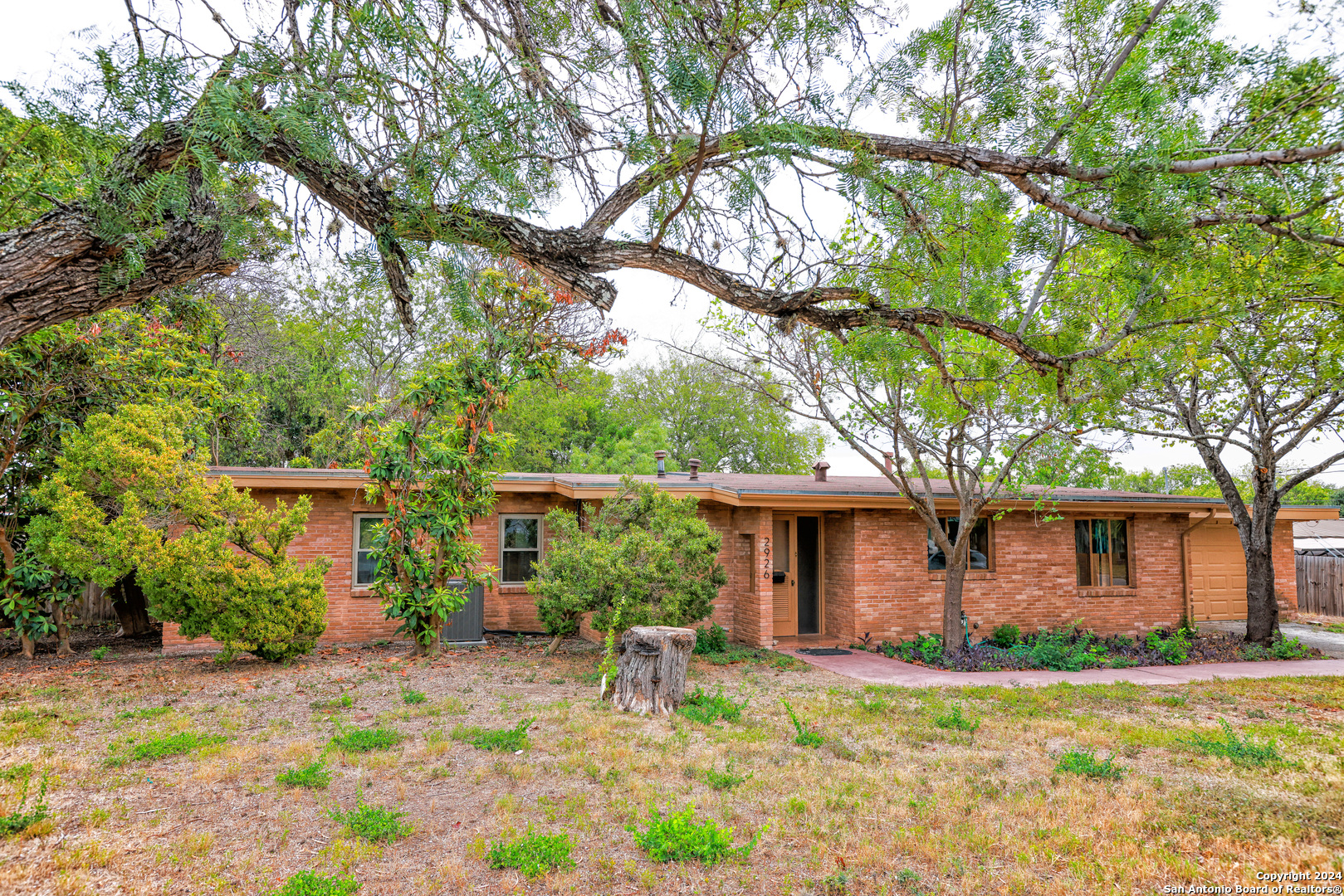 a house view with a sitting space and garden