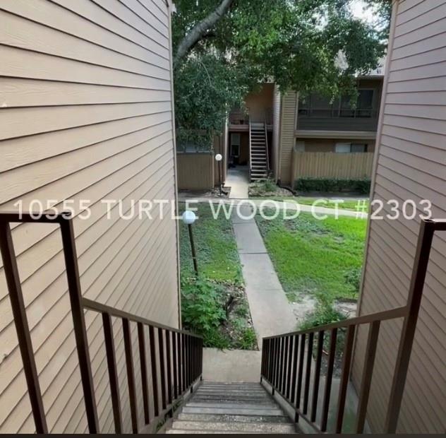 a view of a porch with wooden floor and fence