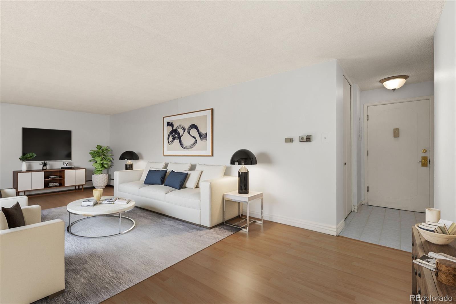 a living room with furniture and a flat screen tv