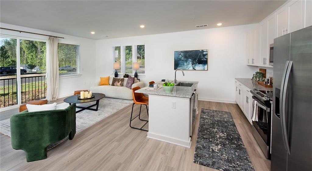 a living room with furniture a large window and a flat screen tv