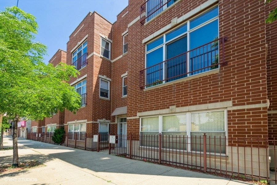 a view of a brick building next to a yard