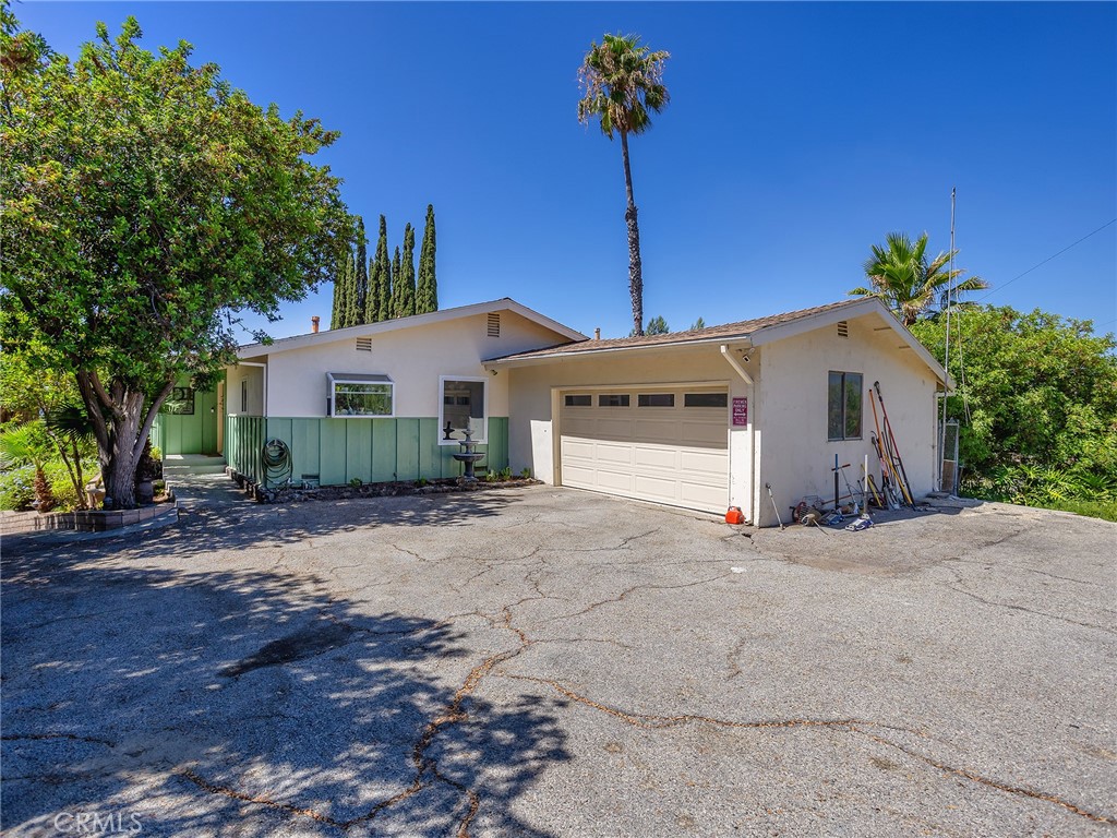 a front view of a house with a yard and a garage