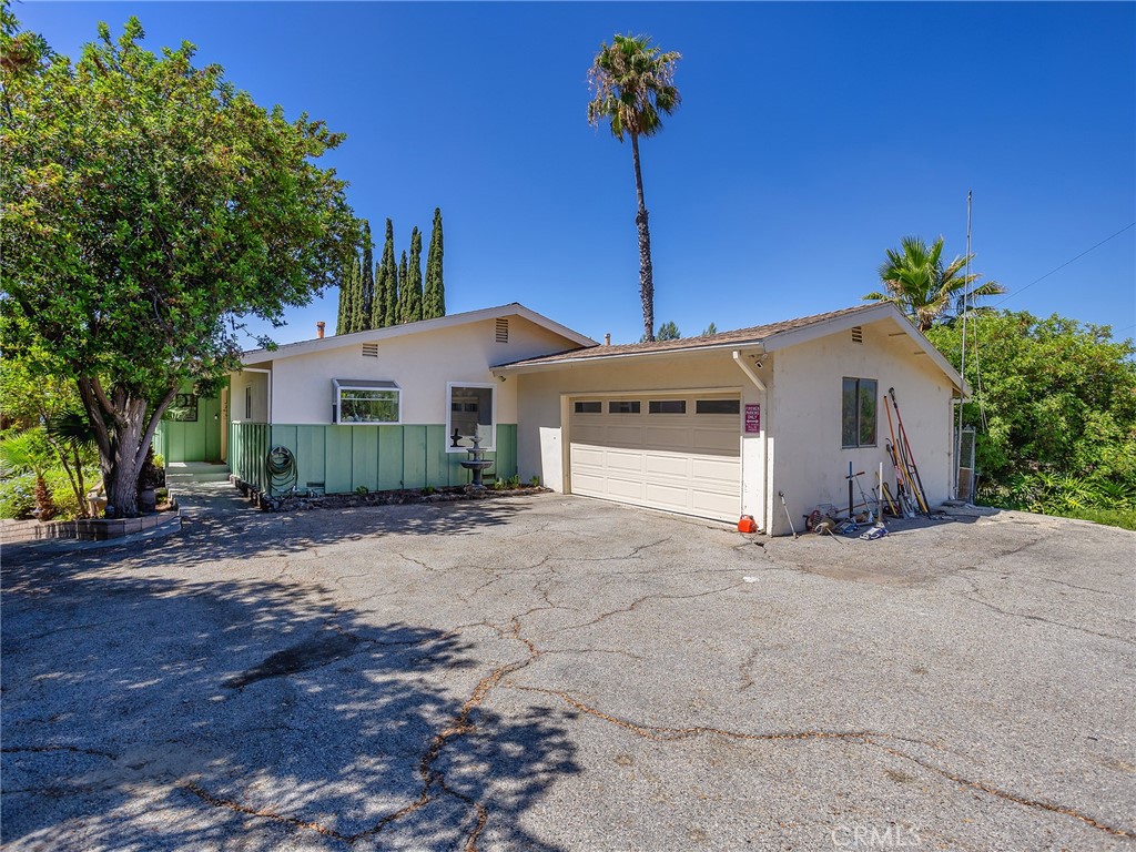 a front view of a house with a yard and a garage