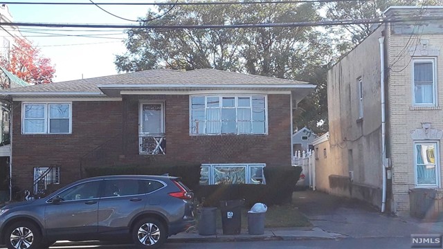 a front view of a house with parking space