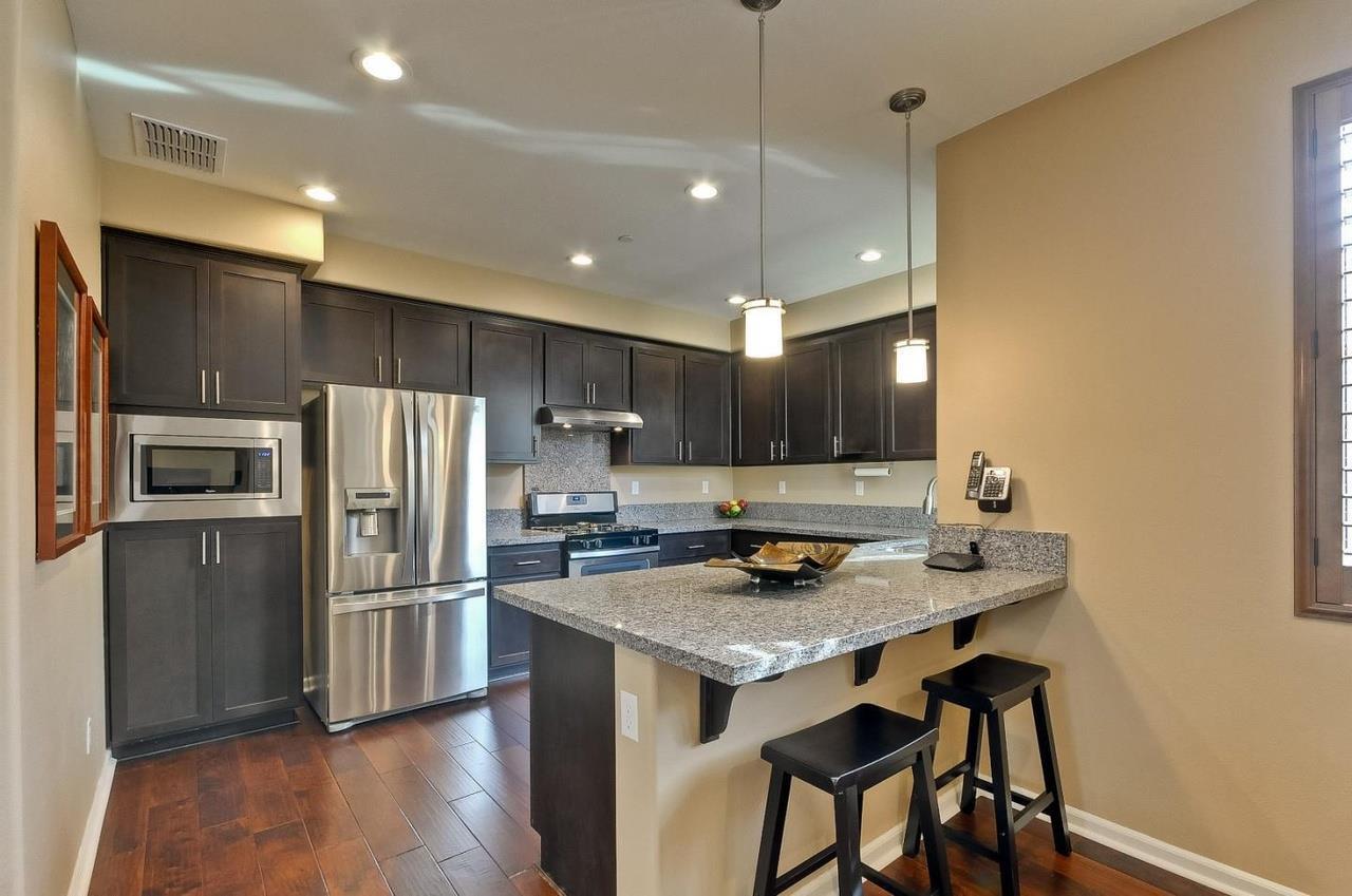 a kitchen with refrigerator cabinets and wooden floor