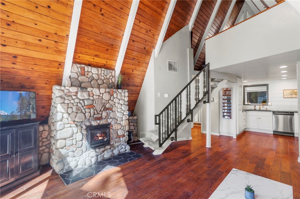 a living room with wooden floors and a fireplace