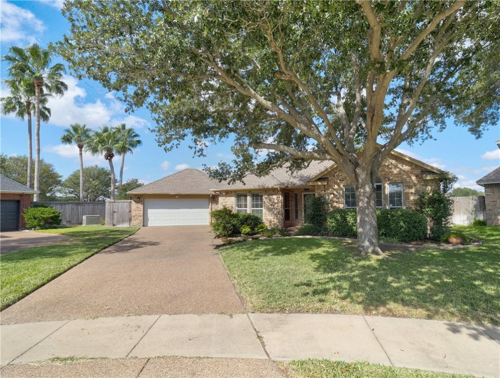 a front view of a house with a yard and trees