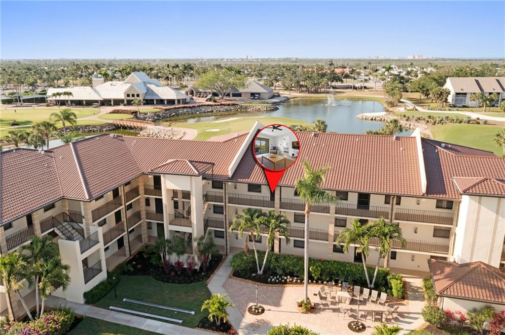 an aerial view of residential houses with outdoor space and lake view