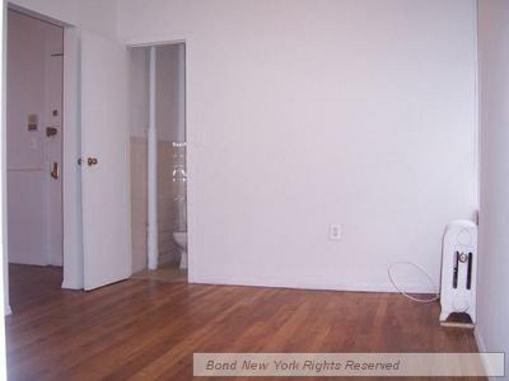 a view of hallway with wooden floor