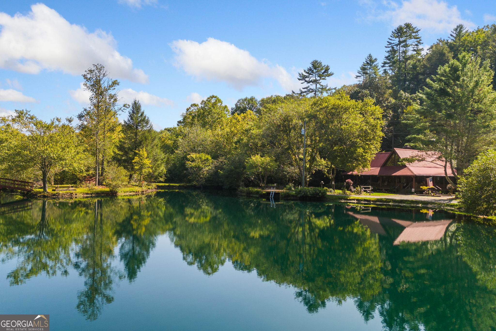 a view of swimming pool and lake from inside of house