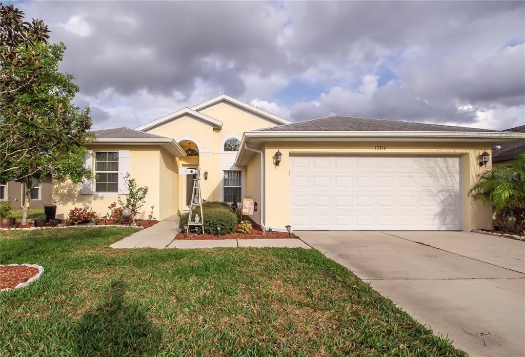 a front view of a house with a yard and garage