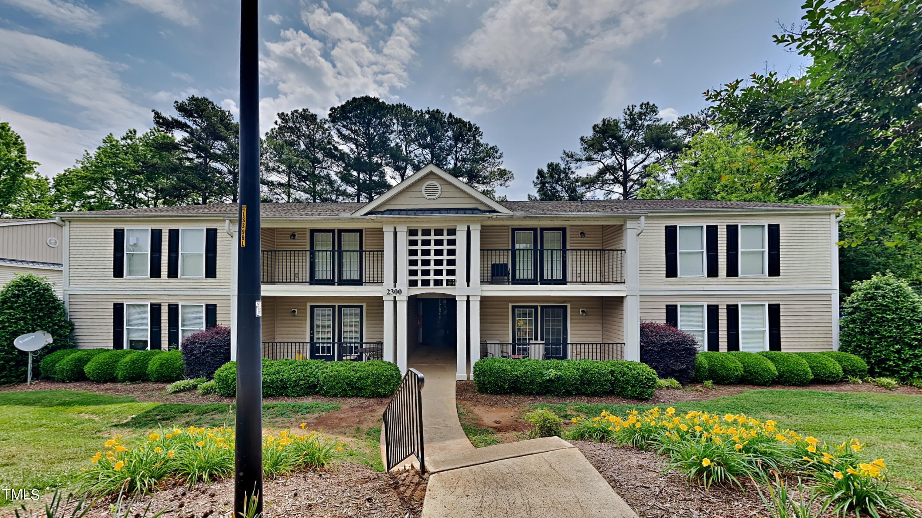 front view of a brick house with a yard