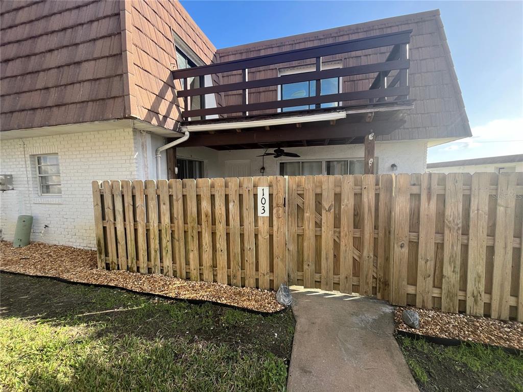 a view of a house with a backyard