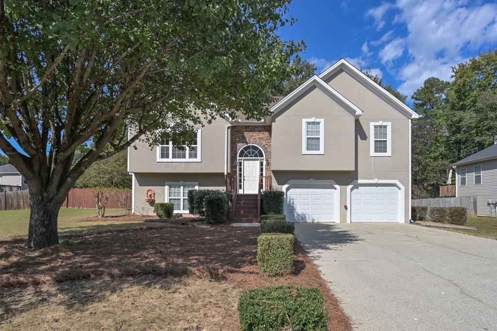 a front view of a house with a yard and garage