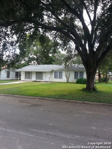 a front view of a house with a yard and a garage