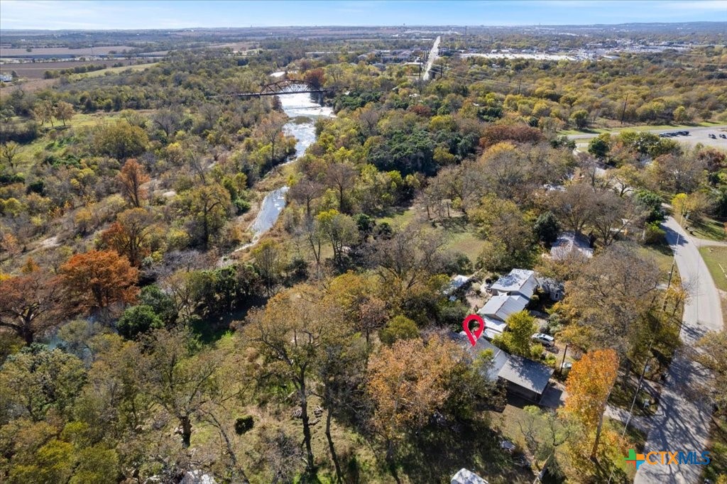 an aerial view of house with yard and mountain view in back