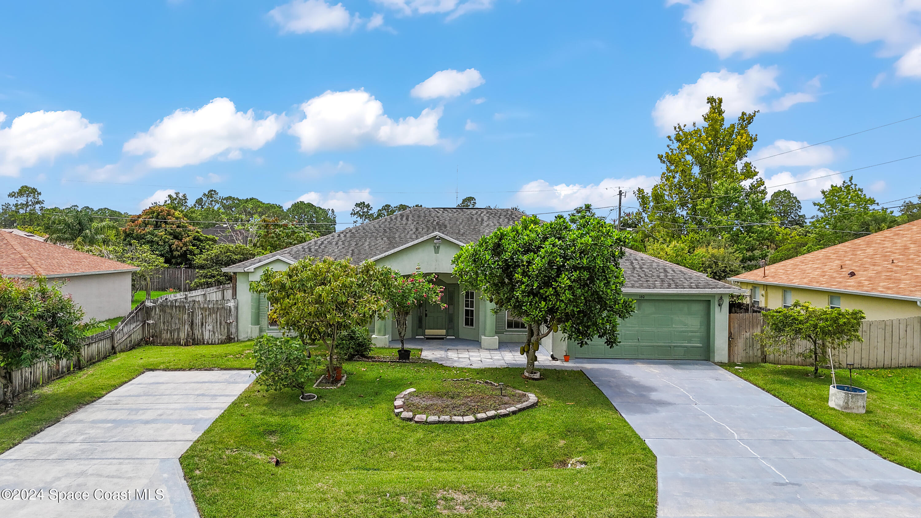 a view of a house with a yard and a garden