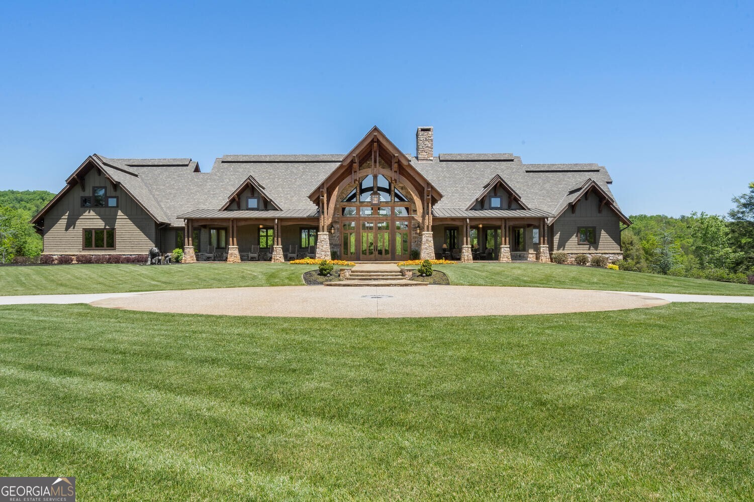 a front view of a house with a garden and yard