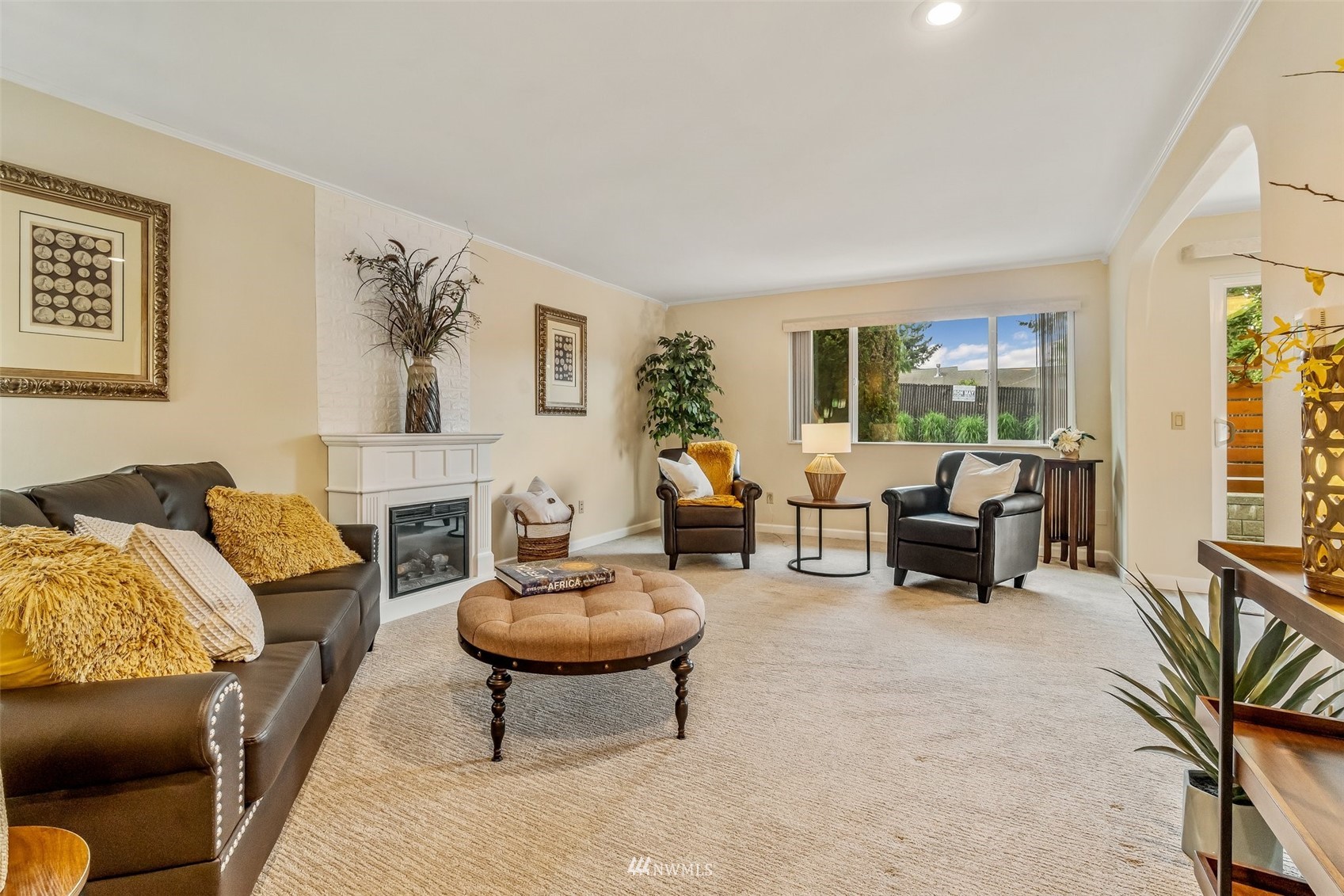 a living room with furniture and a fireplace