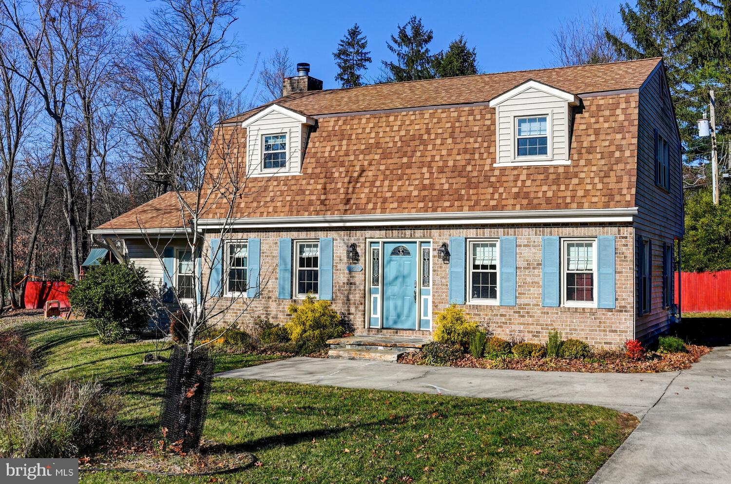 a front view of a house with yard and green space