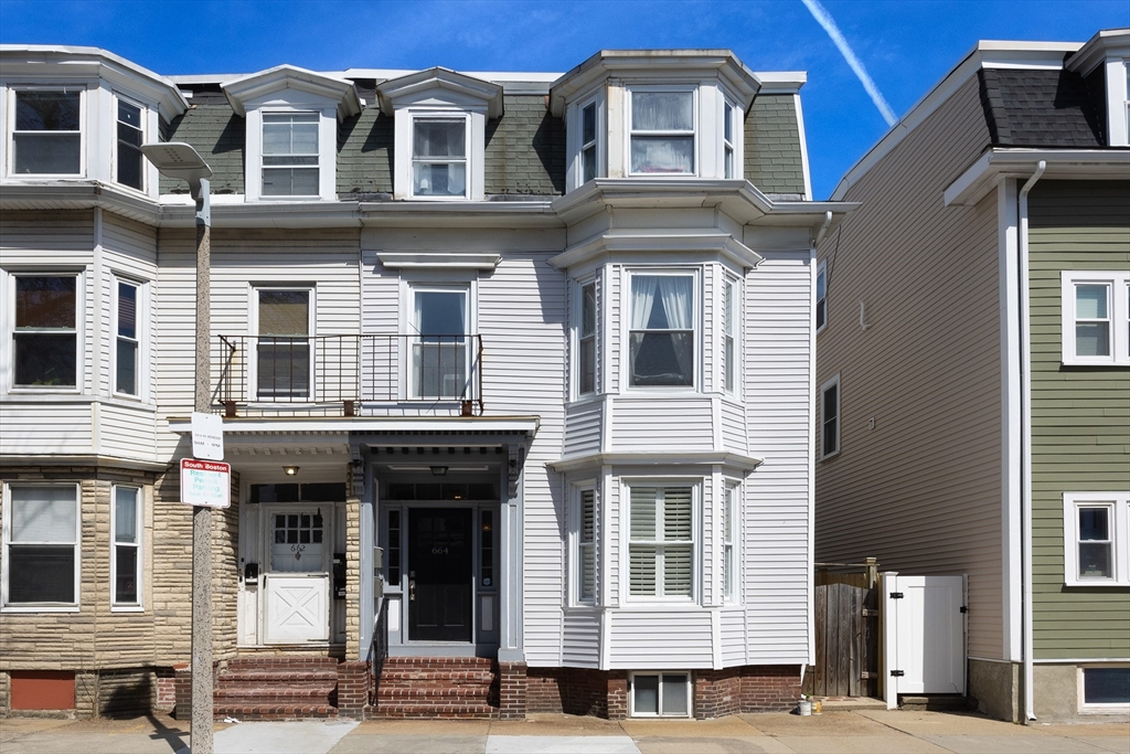 a front view of a residential apartment building with a yard