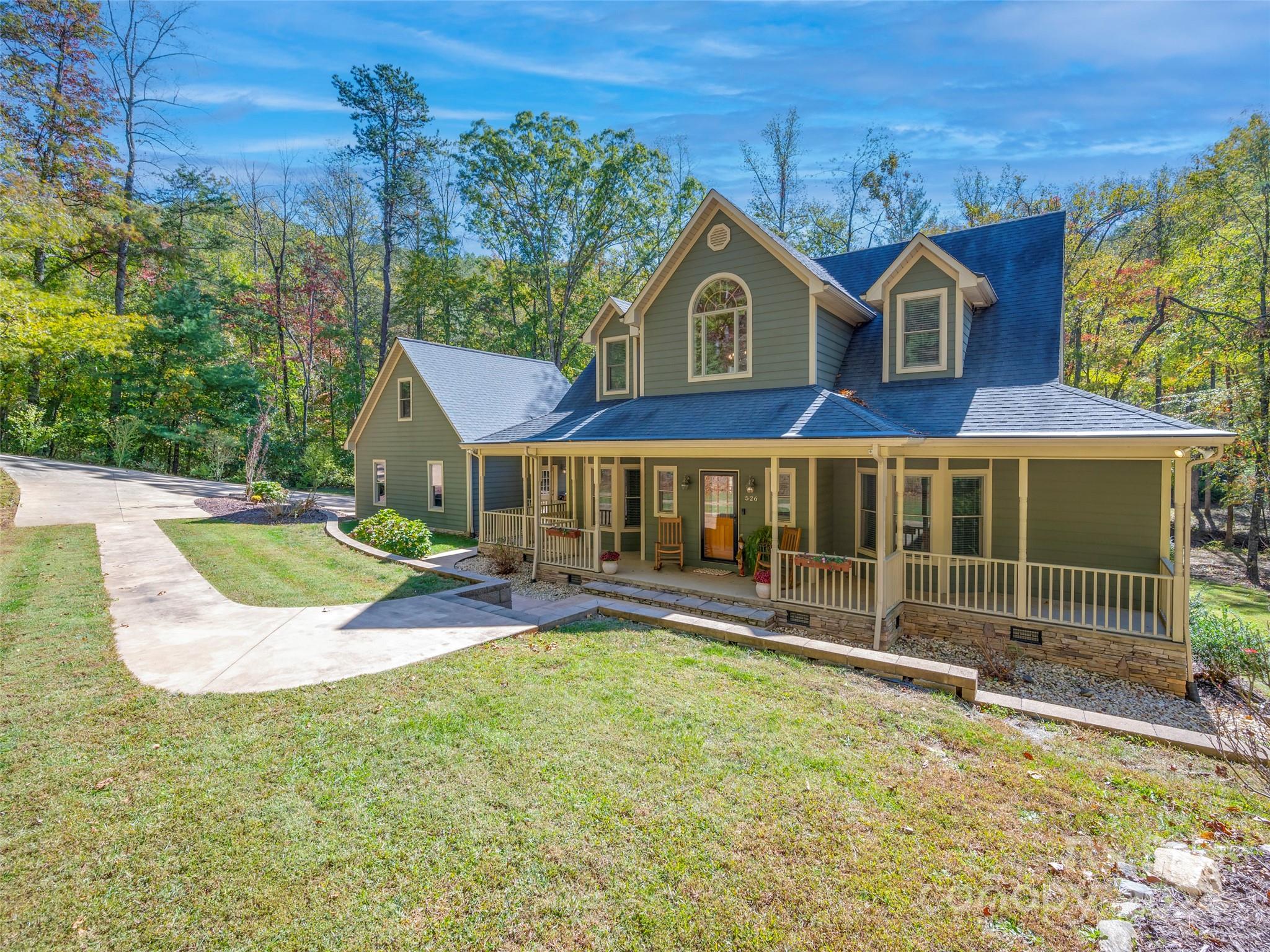 a view of a house with a yard porch and sitting area