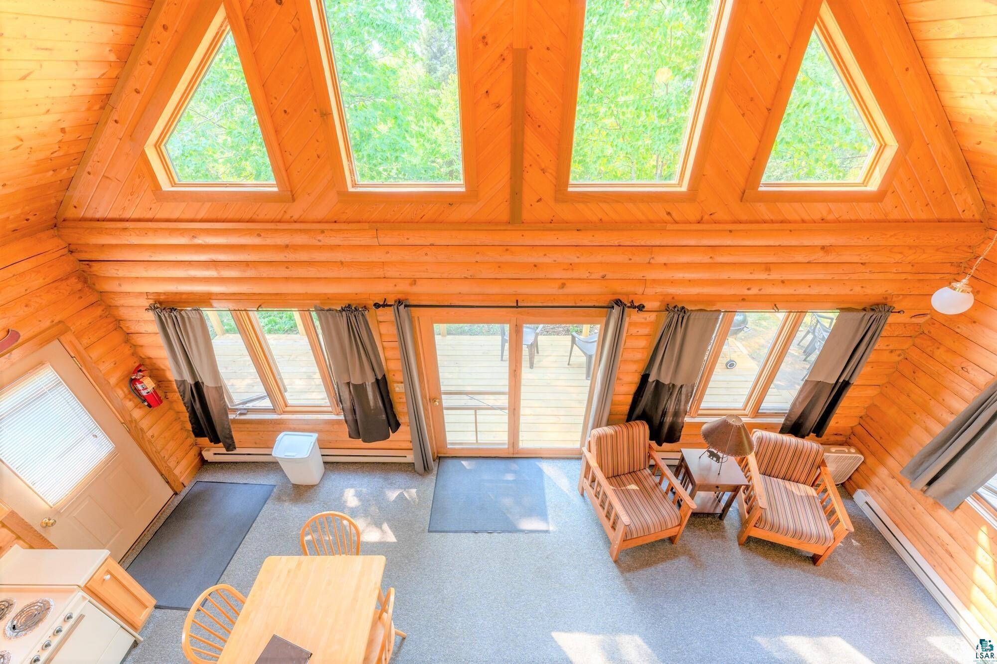 Living room with high vaulted ceiling and a wealth of natural light