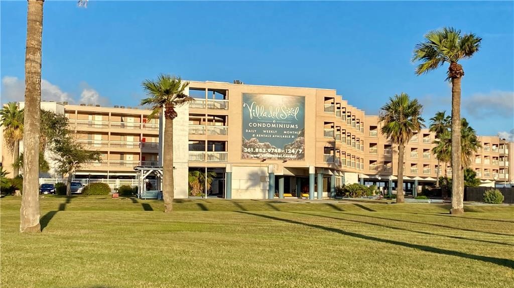 a front view of a building with a fountain