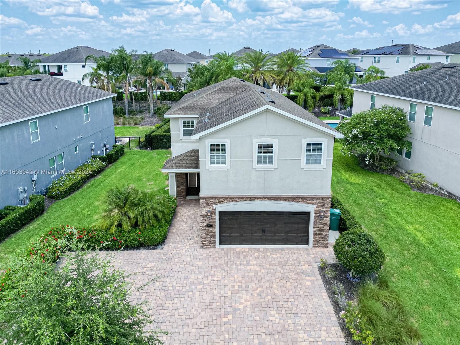 an aerial view of a house with a yard and garage