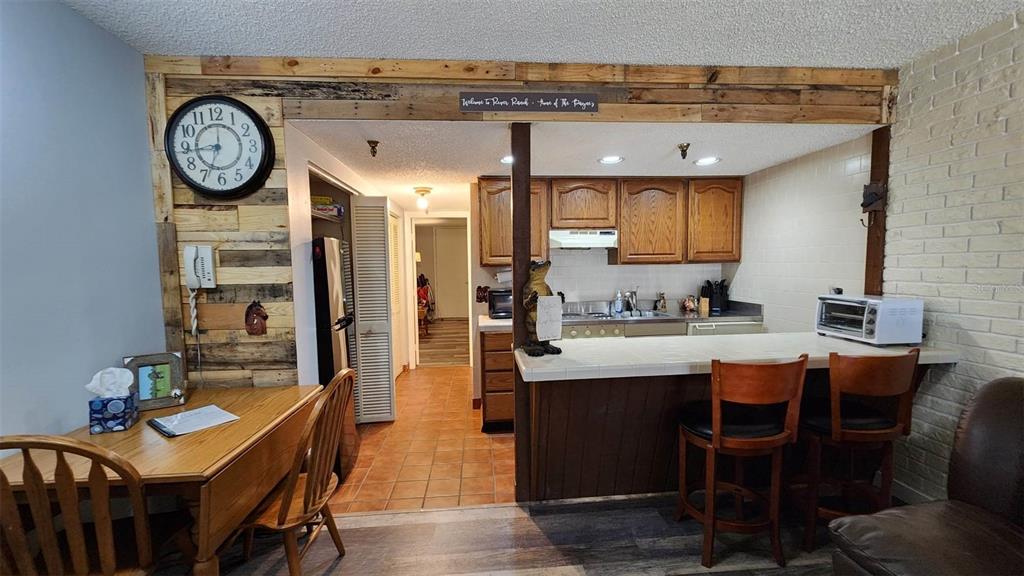 a view of a kitchen with granite countertop a table and chairs