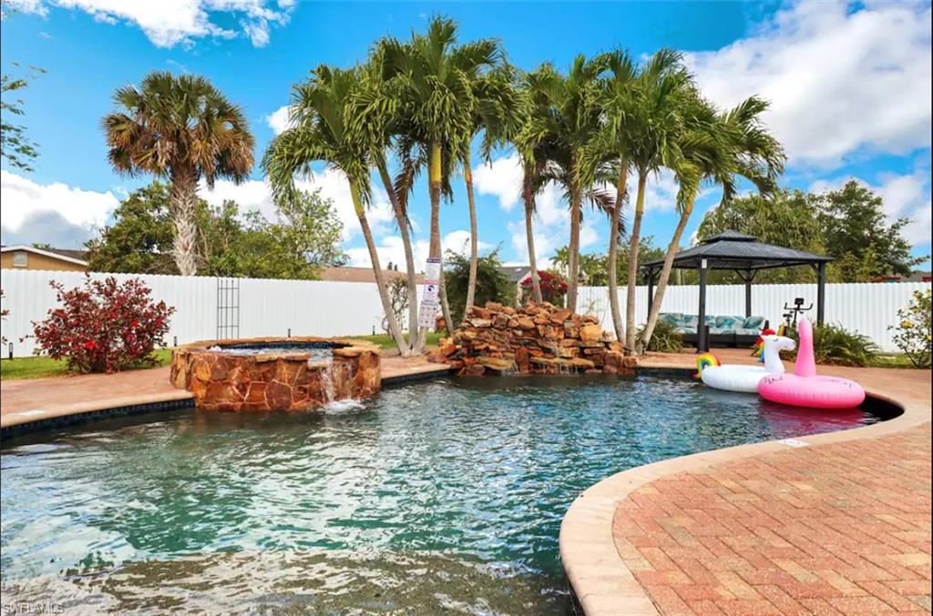 an outdoor sitting area with swimming pool