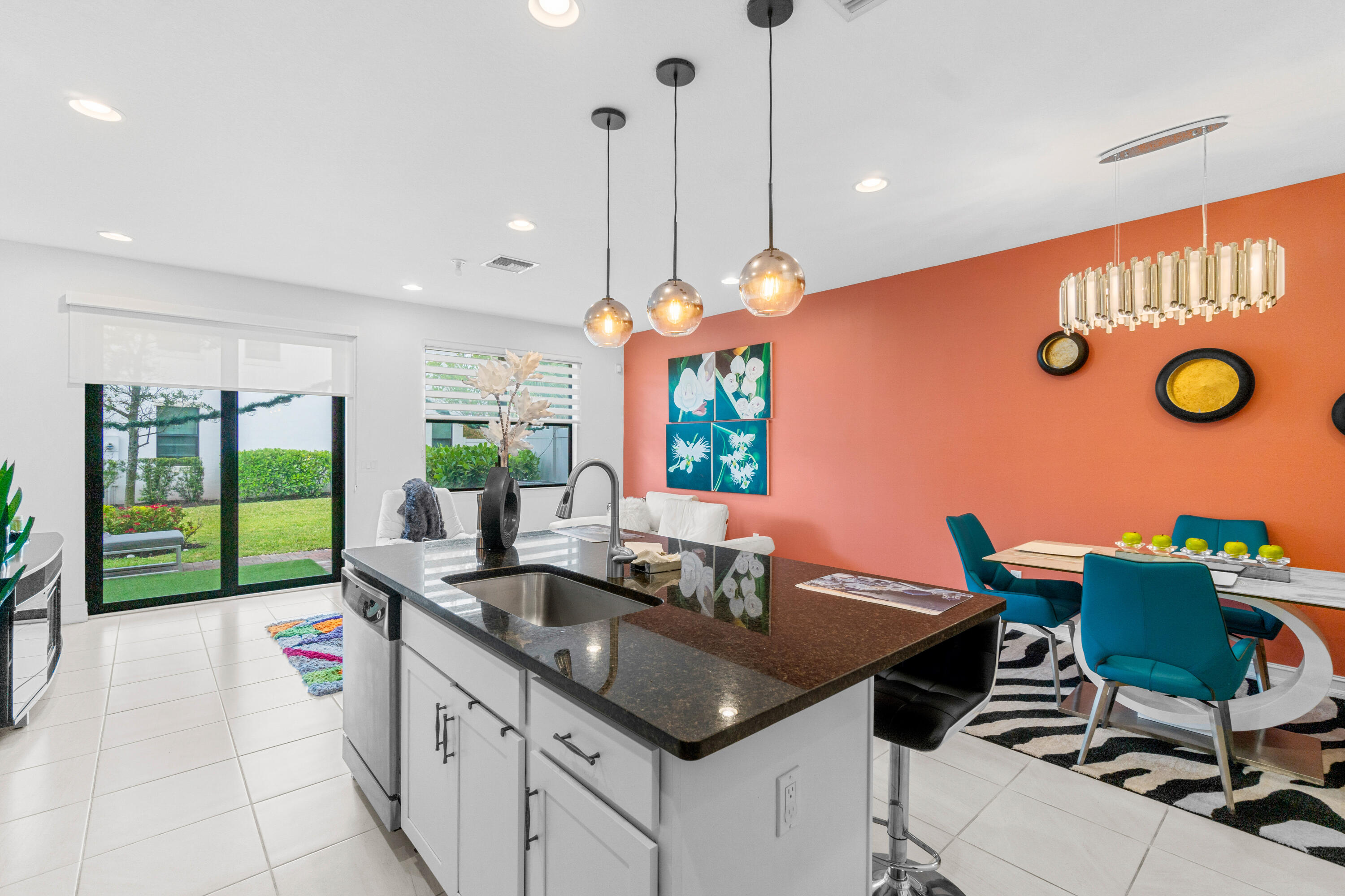 a kitchen with a table chairs and a view of living room