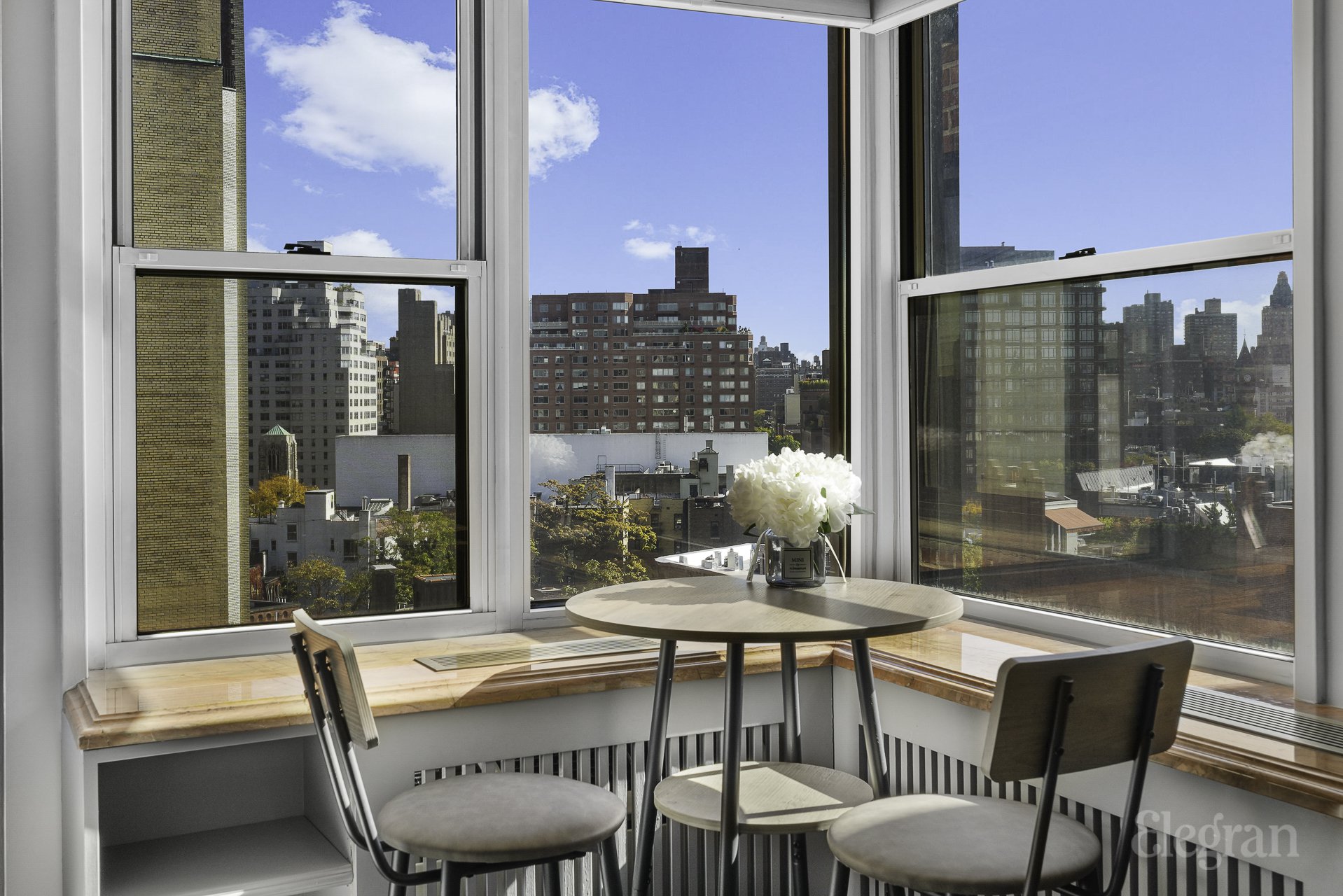 a dining room with furniture and a floor to ceiling window