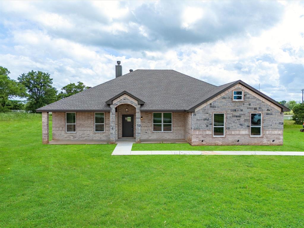 a front view of house with yard and green space