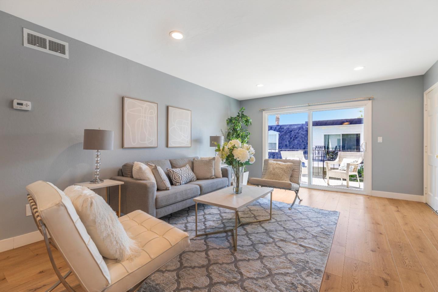 a living room with furniture and wooden floor