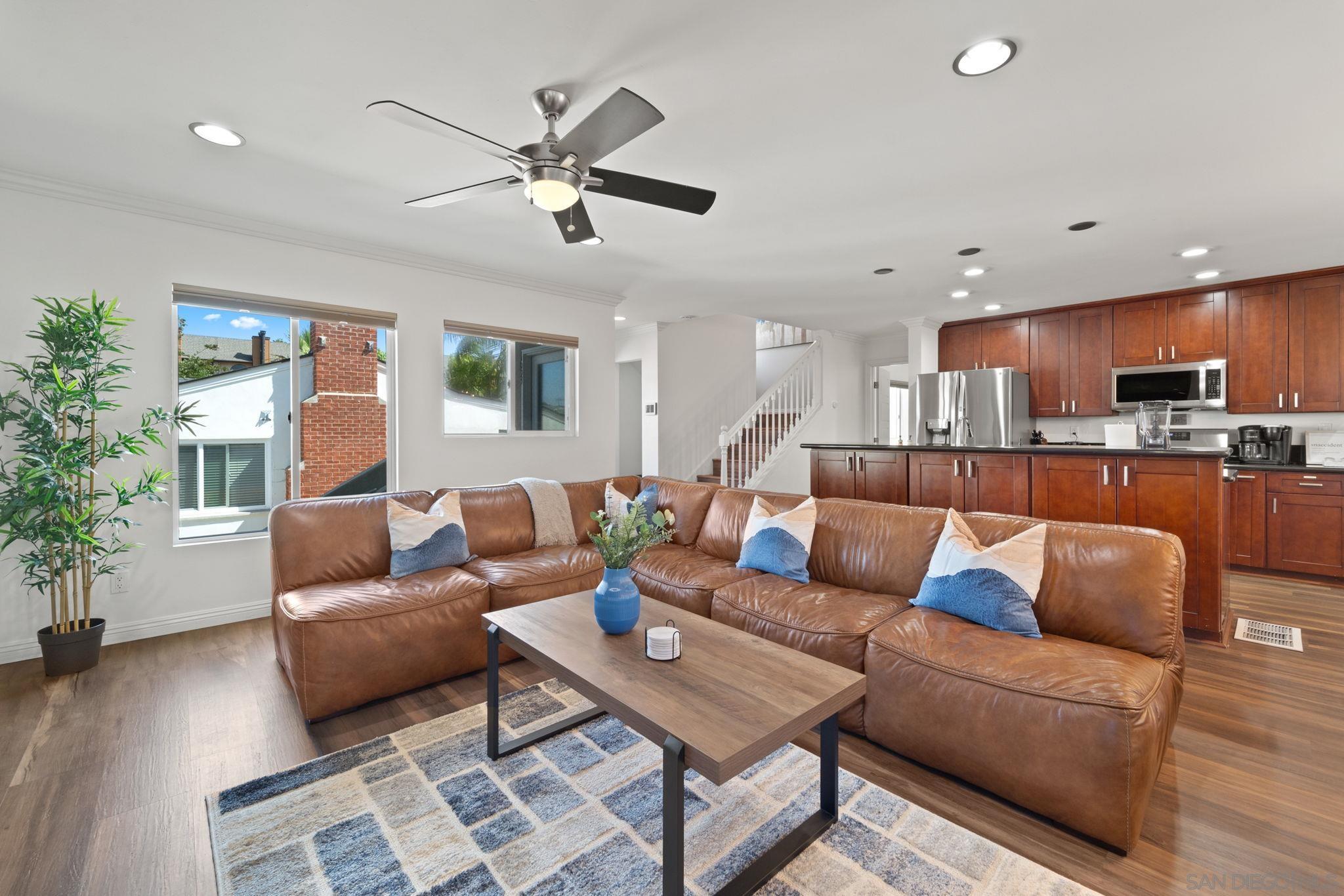 a living room with furniture and kitchen view