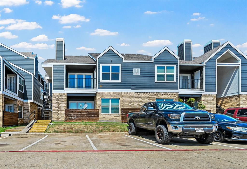 a car parked in front of a brick house