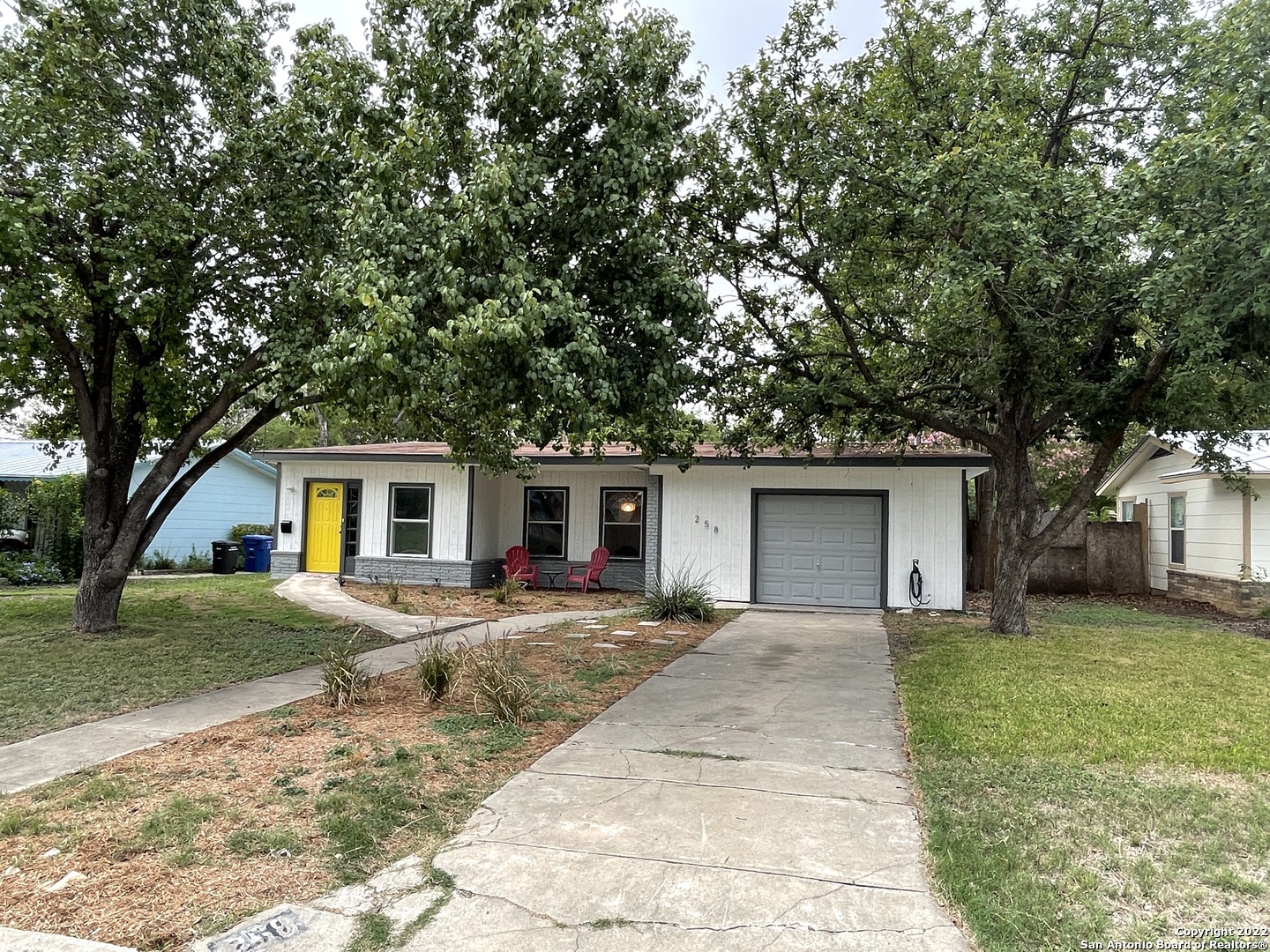 a front view of house with yard and trees