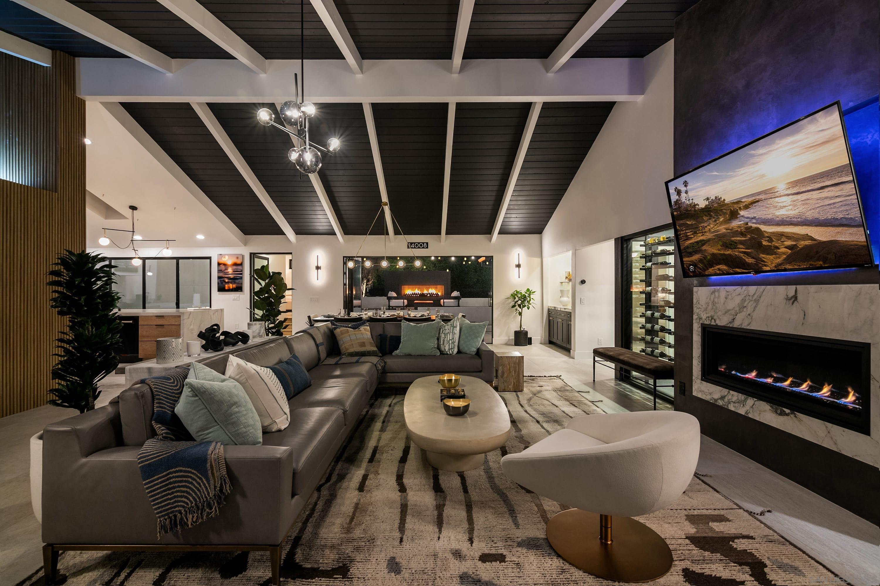 a living room with furniture a fireplace and a flat screen tv