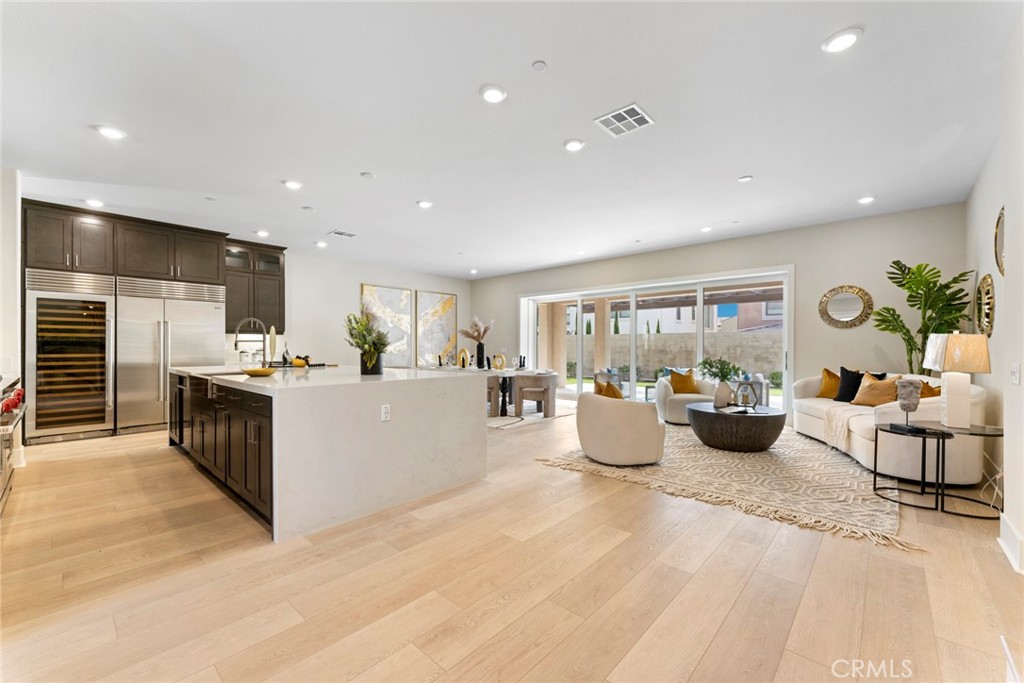 a large room with kitchen island a large window in it