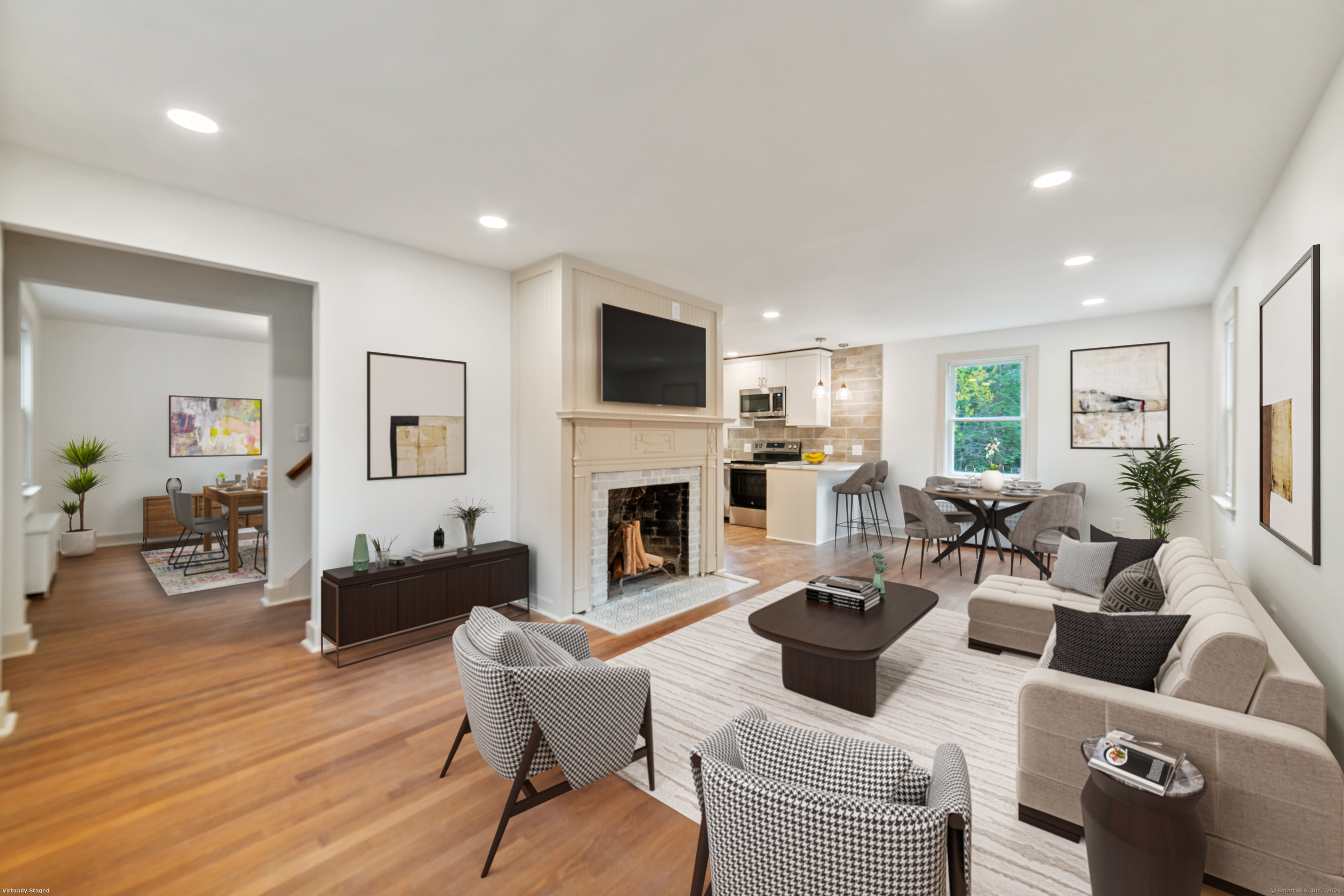 a living room with furniture a fireplace and a flat screen tv