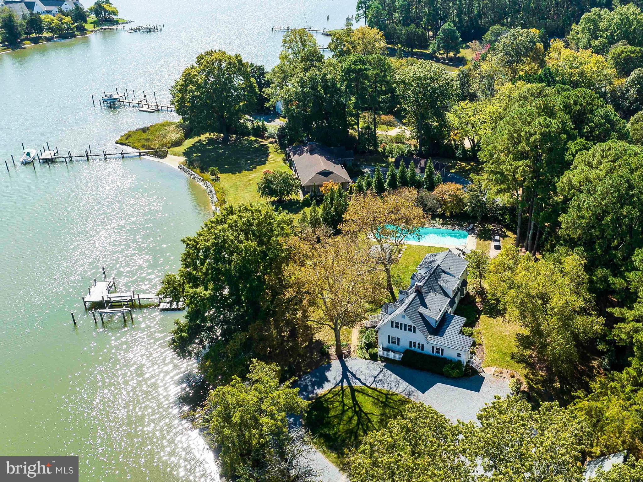 an aerial view of a house with a yard and lake view